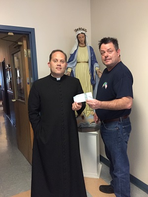 Grand Knight Kevin Strommer presents little lambs pre-school director with a check for $1000, which NYS council of Knights of Columbus matched.